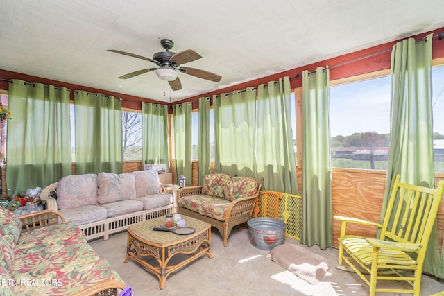 living room with ceiling fan and carpet floors