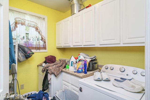 laundry area with washer / dryer and cabinets