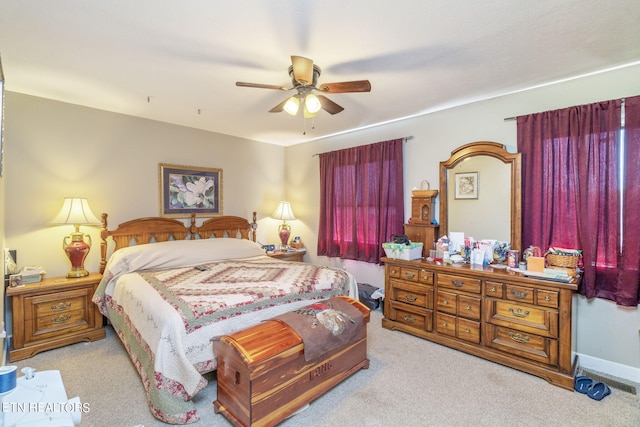 bedroom featuring light colored carpet and ceiling fan