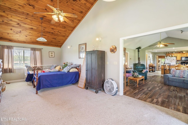 bedroom with high vaulted ceiling, a wood stove, white refrigerator with ice dispenser, wood ceiling, and hardwood / wood-style floors