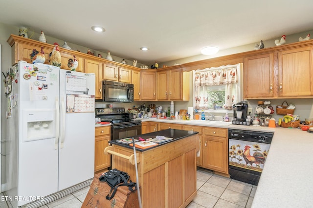 kitchen featuring sink, light tile floors, a kitchen island, and black appliances