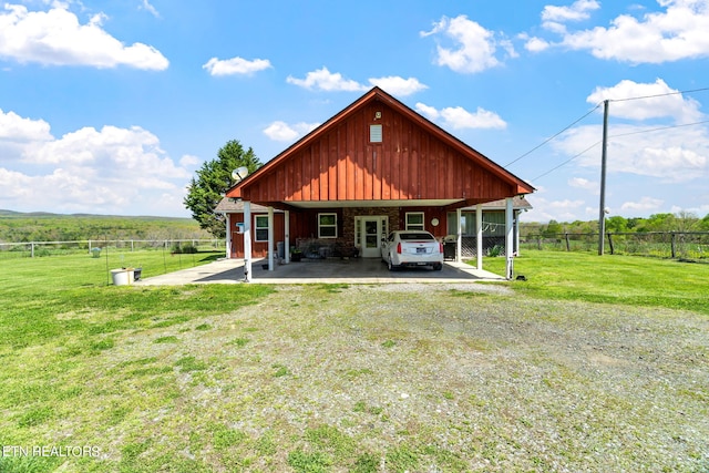 back of property featuring a yard and a carport