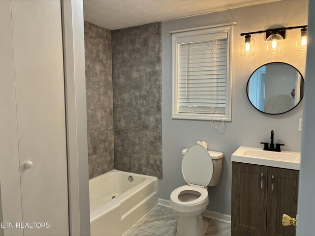 full bathroom with vanity, tub / shower combination, toilet, and a textured ceiling