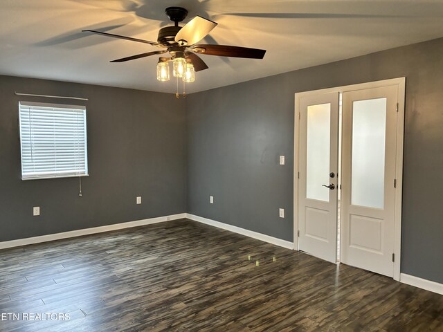 empty room featuring ceiling fan and dark hardwood / wood-style flooring