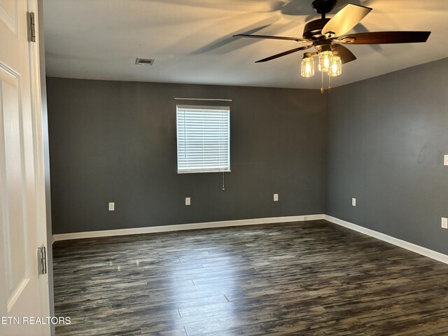 spare room with dark hardwood / wood-style floors and ceiling fan