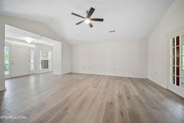 unfurnished living room with ceiling fan, vaulted ceiling, and light wood-type flooring