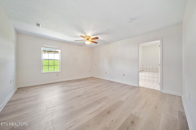 empty room featuring light hardwood / wood-style flooring and ceiling fan