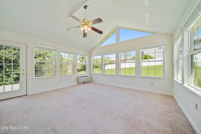 unfurnished sunroom featuring plenty of natural light, ceiling fan, a wall mounted AC, and lofted ceiling