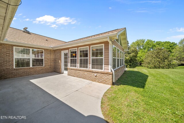 exterior space featuring a patio area and a lawn