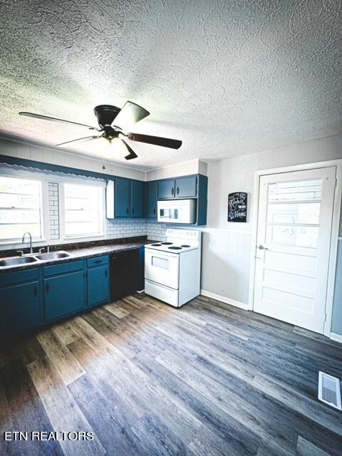 kitchen featuring white appliances, ceiling fan, dark hardwood / wood-style floors, tasteful backsplash, and sink