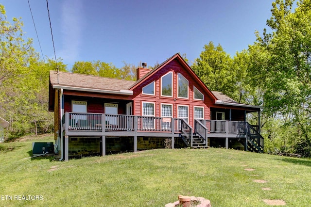 back of house featuring a wooden deck, central AC unit, and a lawn