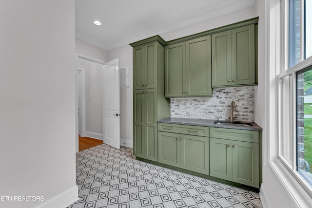 kitchen with sink, plenty of natural light, decorative backsplash, and green cabinetry