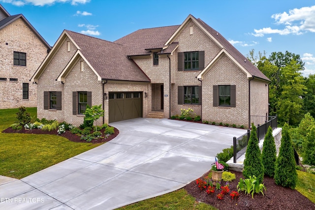 view of front of property featuring a garage and a front lawn