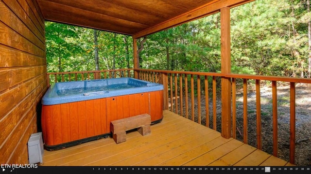 wooden deck featuring a hot tub