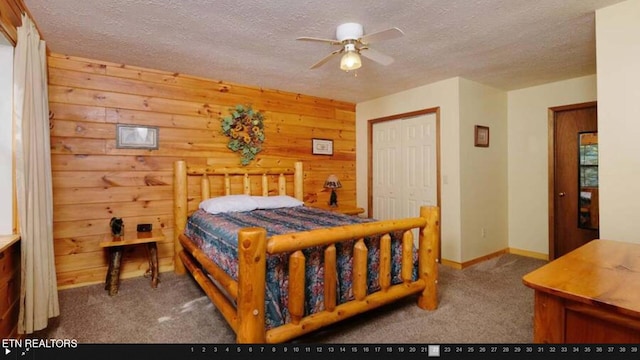 carpeted bedroom with a closet, a textured ceiling, and ceiling fan