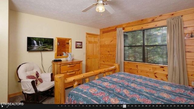 carpeted bedroom with a textured ceiling and ceiling fan