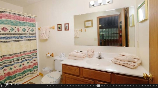 bathroom featuring vanity with extensive cabinet space and toilet