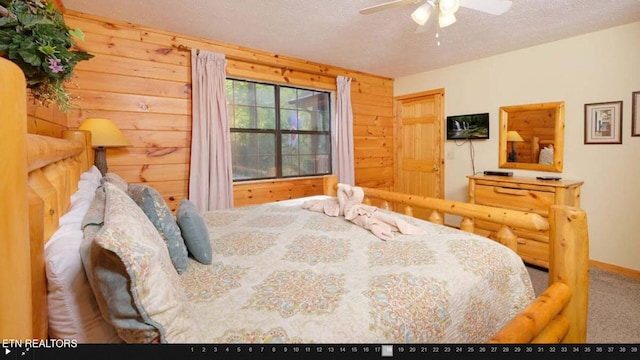 bedroom featuring a textured ceiling, carpet floors, and ceiling fan