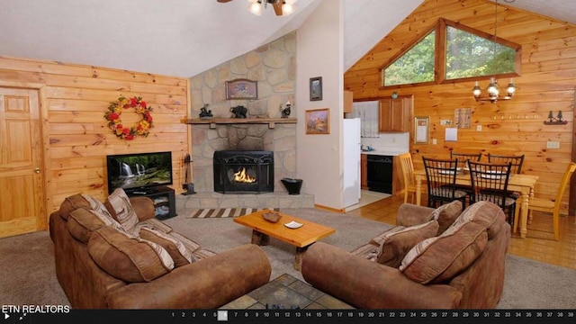 living room with high vaulted ceiling, carpet, and a stone fireplace