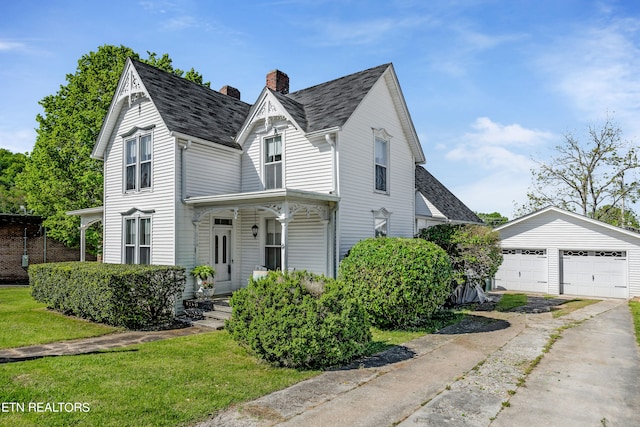 view of front of property featuring an outdoor structure and a garage