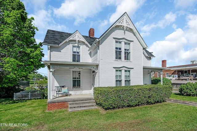 victorian home with covered porch and a front yard