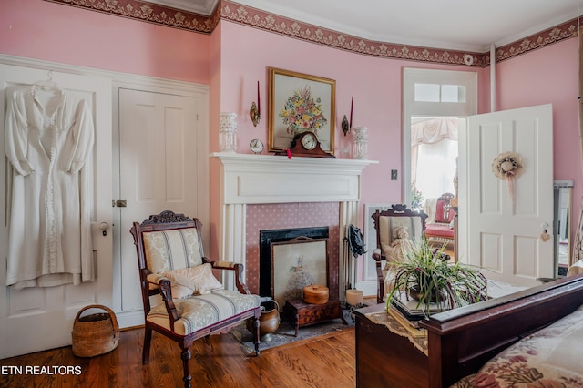 sitting room with a fireplace and hardwood / wood-style flooring