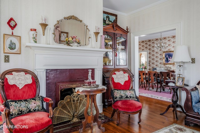 sitting room with dark hardwood / wood-style flooring and crown molding