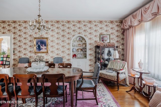 dining room featuring hardwood / wood-style floors and an inviting chandelier