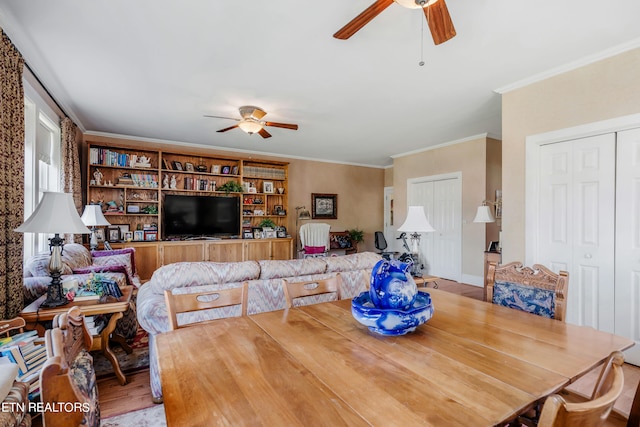 dining space with wood-type flooring, ceiling fan, and crown molding