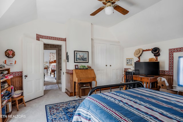 bedroom featuring a closet, ceiling fan, vaulted ceiling, and carpet flooring