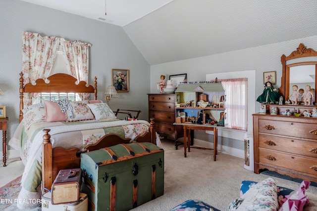 carpeted bedroom with lofted ceiling