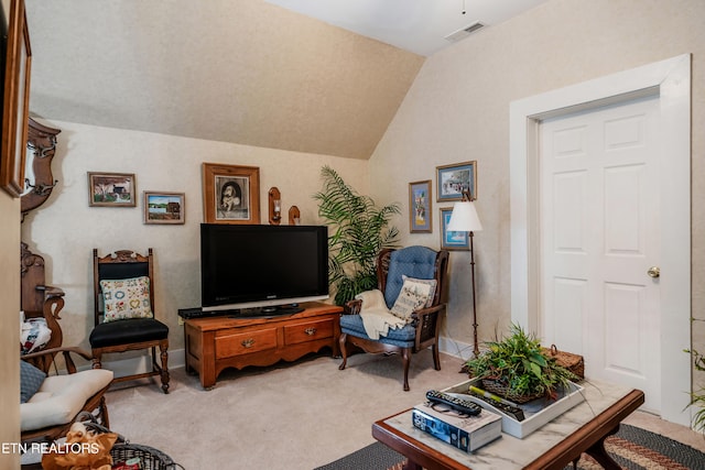 carpeted living room with lofted ceiling