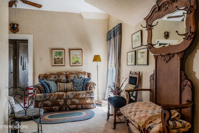 living room with lofted ceiling, carpet floors, and ceiling fan