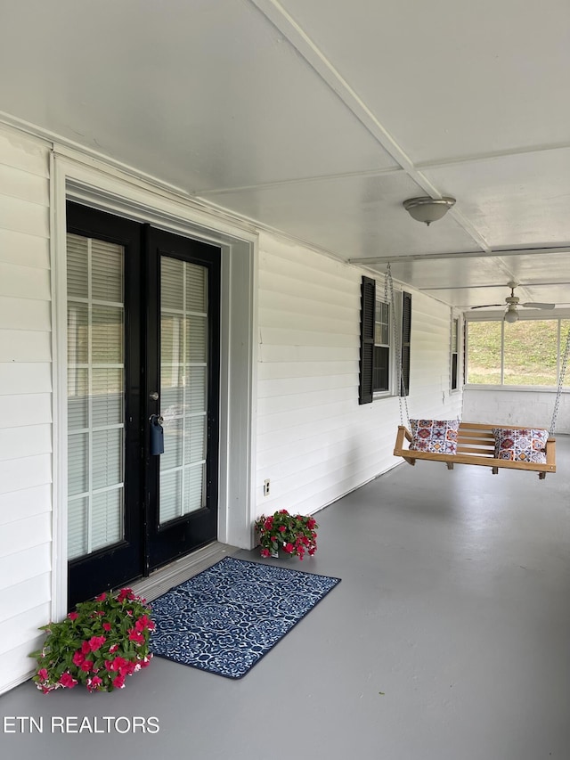 view of exterior entry featuring covered porch