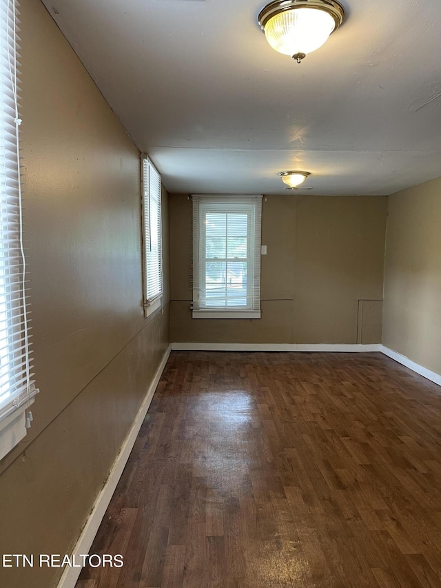 unfurnished room featuring dark hardwood / wood-style floors