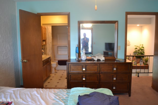 tiled bedroom featuring connected bathroom