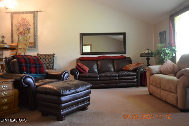 carpeted living room with lofted ceiling