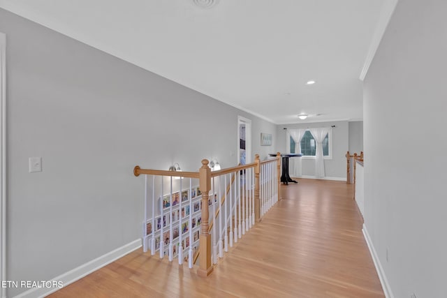 hallway featuring crown molding and light wood-type flooring