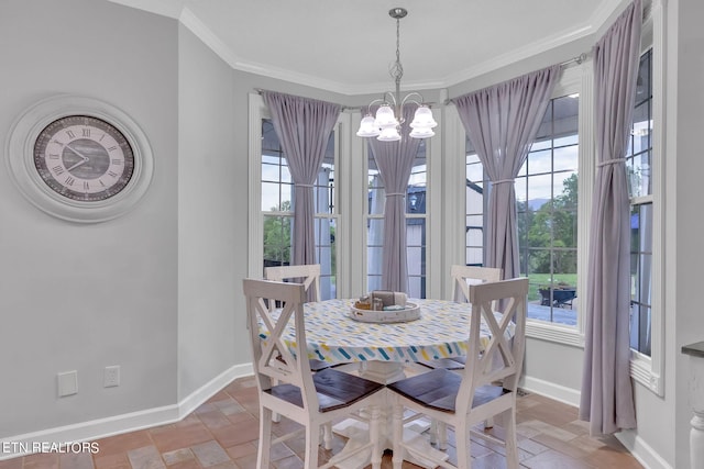 dining room featuring crown molding and an inviting chandelier