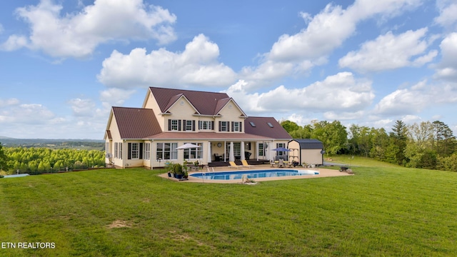 back of property featuring a patio and a yard