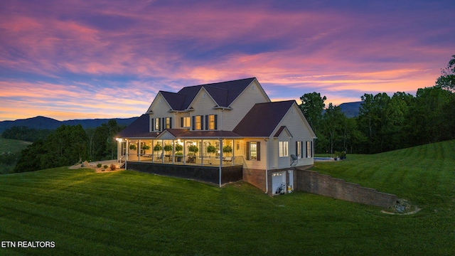 view of front of home featuring a yard and a garage