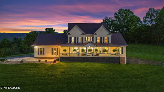 view of front of property featuring a yard and covered porch