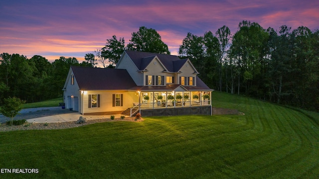 back house at dusk with a yard