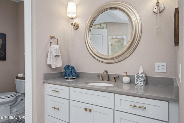 bathroom featuring toilet and vanity