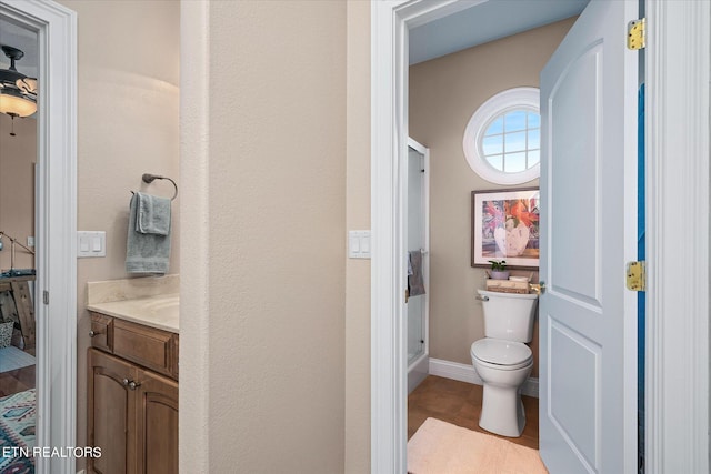 bathroom featuring toilet, vanity, and tile patterned floors