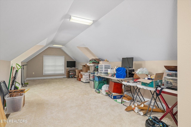 additional living space with carpet floors and vaulted ceiling