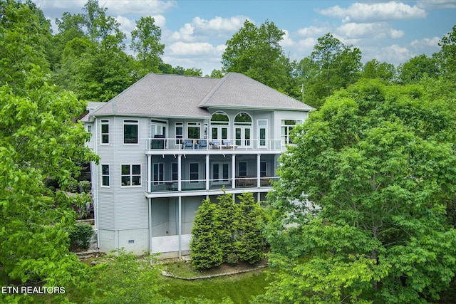 back of property with a balcony