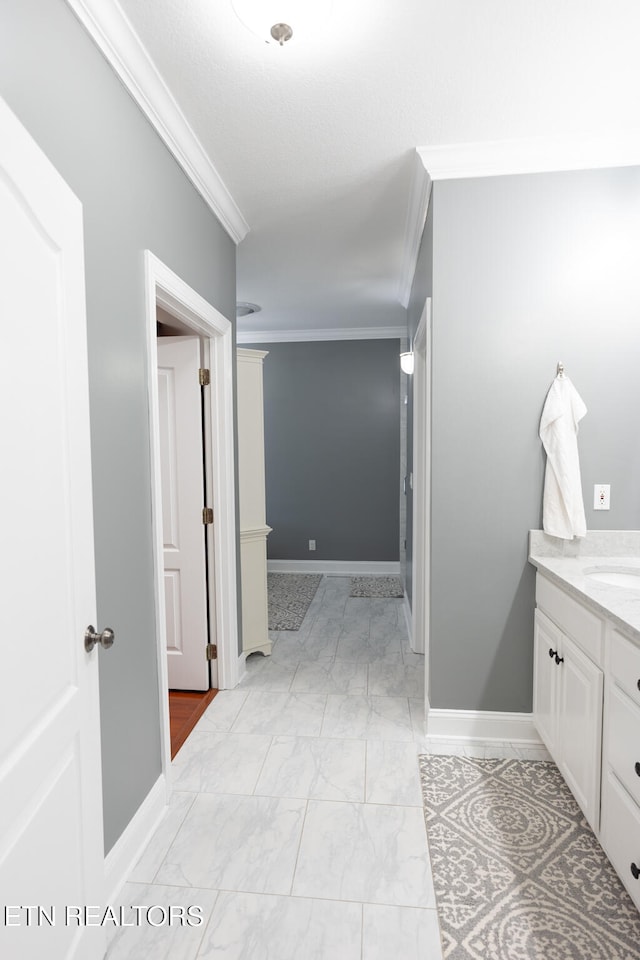 bathroom with vanity and ornamental molding