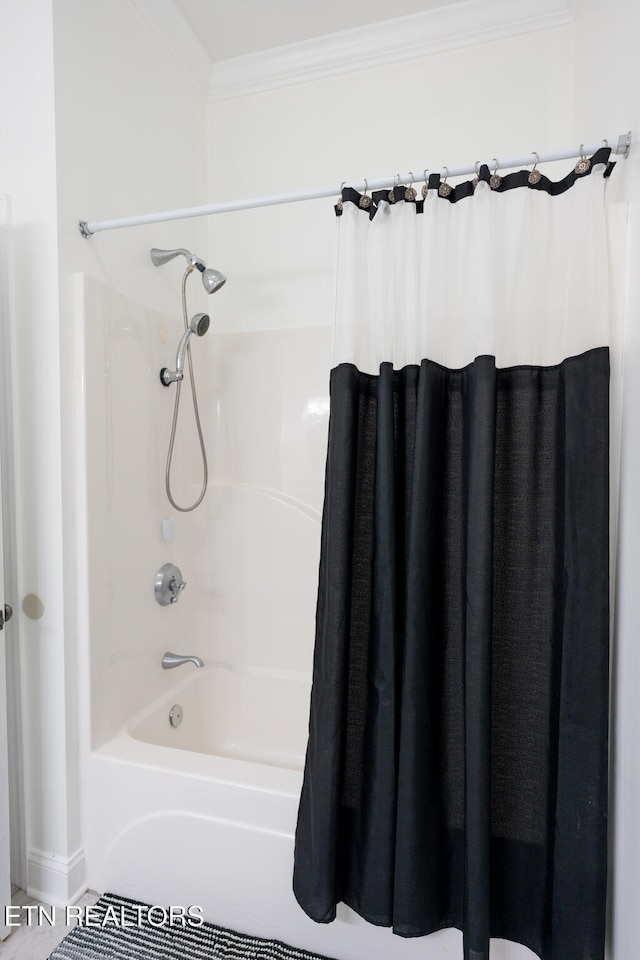 bathroom featuring shower / bath combination with curtain and crown molding