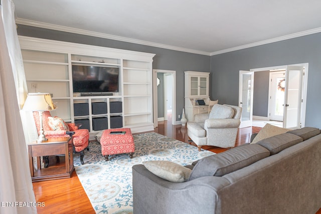 living room featuring crown molding and hardwood / wood-style flooring